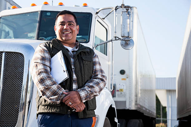 A driver beside his truck
